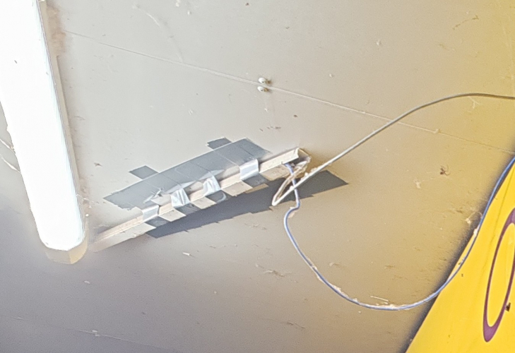 Lash up outside shop 
This trunking has been hanging down for months, I'm guessing it is the self adhesive type that doesn't always adhere to certain types of surface. Don't think much of the repair. 
