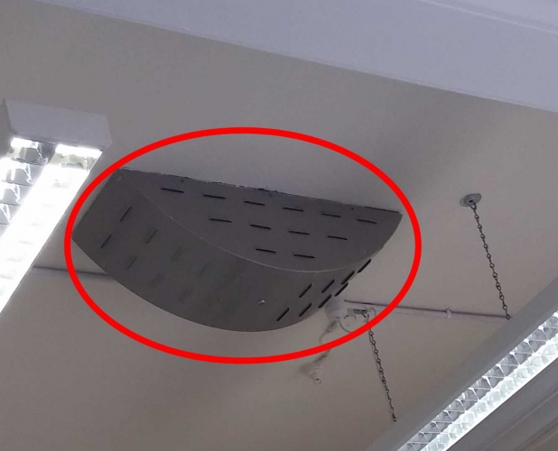 Any ideas what this is?
Any ideas what this metal curved box is? It's mounted on the ceiling in the front office of my workplace. It used to be a post office with a sorting office at the back. I have no idea what it is. The ceilings are quite high, about 15ft. It has a key lock on the bottom which is just visible. 
