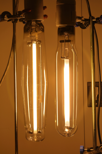U.S.A vs Europe: 1000w High-Pressure Sodium
Two 1000w SON-T lamps which probably couldn't be more different!

On the left is a GE Lucalox which is a high voltage lamp.
And on the right is a Radium RNP-T which is a low voltage type.

Check out the differences in the arc tube length and diameters! So what do you prefer? Long & thin or short & girthy? 
It's interesting to see these two types of SON lamps lit together.

Was quite bright! 260,000 lm of golden yellow goodness! 
