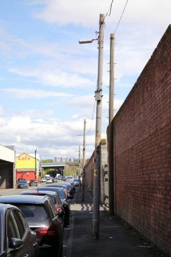 Old catenary supply columns 1
While out for a walk around the Liverpool docks, I spotted loads of these old steel columns with overhead catenary supply cables that probably date from the late 1940's or early 1950's.
I've seen similar columns with old Wardle SOX lanterns on them in some places of Liverpool like Gateacre.
I wonder if the original SOX control gear is still inside that gearbox/cutout?
You can tell that these are old as some are rust at the base and you can see about a million layers of paint on it.
