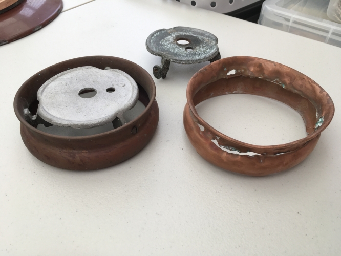80+ year old NOS parts.
I contacted William Sugg & Co to see if they could help me with a few bits and bobs but while for economical reasons, they don't make stuff anymore for the old stuff, Chris Sugg had a rummage and located a bowl and a new windguard c/w tripod heatplate that has been in storage for god knows how long!
This was the main worry as one of the legs had broken off the tripod and the windguard was quite badly crushed and cracked.
He even supplied me with new gas burners and has given me details where I can source a new pilot light jet from a company in Italy.
