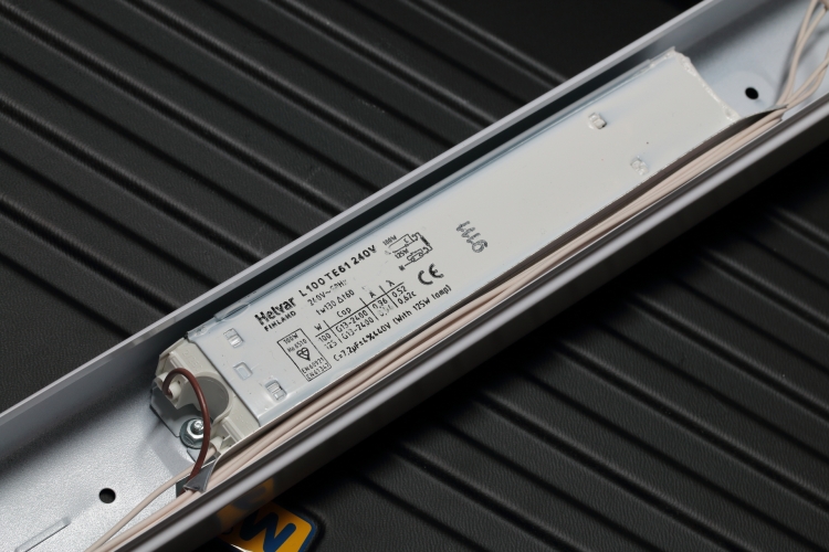 Helvar 100/125w 8ft T12 Choke
One of two Helvar switch-start/preheat ballasts found installed in a twin-lamp Fitzgerald Lightpack.

 Operates a 100w lamp in lagging configuration with capacitor across the mains for PFC.
 Operates a 125w lamp in leading configuration with capacitor in series with the ballast. 

 Very large, sturdy and well made ballasts, will probably last for ever...

