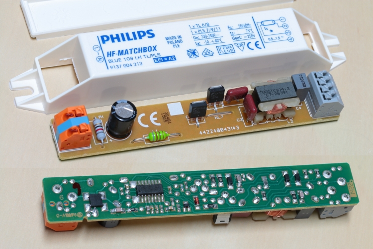 Philips Matchbox Blue
Philips Matchbox electronic high-frequency ballast for 1 x 6 or 8w T5 lamp or 1 x 7w, 9w or 11w PL-S lamps.

Shown with the PCB removed from the case and an insert picture showing the reverse side.

The two TO251 transistors are Fairchild Semiconductor SSU1N50B 1.3a 520v N channel MOSFET's.
The main electrolytic capacitor is a high quality Rubycon 105'c rated 350v 1.8uf unit.

 On the reverse side is a bridge rectifier and a load of SMT passives.

 The main controller is a SOT16 NXP Semiconductors UBA2013T/N5.
 This is a high voltage IC intended to drive and control fluorescent lamps. The
 IC can handle both cold and warm ignition of the lamp. It contains a TON-controlled PFC
 function, a half bridge controller circuit with level shifter and an internal bootstrap diode to
 drive an external half bridge. It also offers a functionality to properly handle
 fault conditions such as capacitive mode switching, end-of-lamp-life and over-current.

