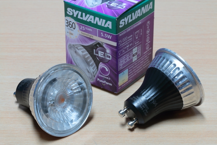 Sylvania 5.5w RefLED+ ES50 GU10 Version 2 
Version 2 of Sylvania's RefLED ES50 series of LED GU10 halogen replacements.

 A great deal of refining has been done to drive down manufacturing costs without sacrificing quality.

 Due to the increased efficiency of the LED modules, the heatsink has been reduced in size and is now formed out of 1mm pressed aluminium instead of the die-cast alloy unit on the V1 lamps. This new process has reduced costs by a factor of five. 

 Special attention has also been taken with the new lens. The goal was to have the first halogen retrofit lamp where the entire front diameter lights up with no visible heatsink rim. This was to enable the lamp to resemble a halogen lamp with no mismatch in colour between the lamp and the fitting, especially recessed downlights. This works very well indeed and the lamp greatly resembles a halogen lamp.

 The driver has not changed much and the LED modules are still mounted on a ceramic PCB like the V1 lamps.

 Also worth noting is the fact that almost all of the components are now sourced in Europe rather than China (the LED modules are now sourced from Japan instead of China) and the end goal is to have zero Chinese components in Sylvania's products.
