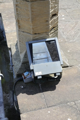 Solid Philips Halide floods.
Most of Caernarfon Castle is now lit by big Philips LED floods, but some of these still survive.
These are really nice floods tbh and is one of my favourite designs!

This one is pictured on the roof of the Eagle tower.
