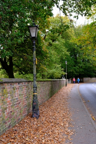 Proper lanterns.
Cast iron columns look old but I'm not sure about the lanterns. 
At least they are burning SON-T lamps and have glass refractor rings!
Spotted in Dunham Massey.
