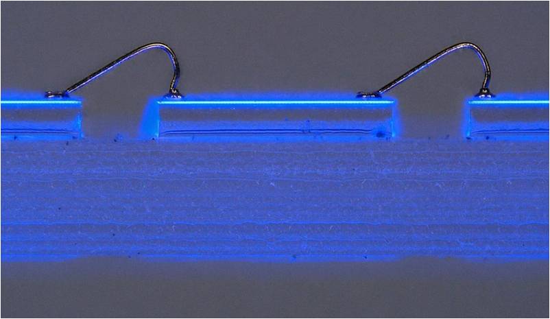 LED Filament without phosphor
Microscopic view of an individual LED chip on the LED filament.  Note how the light emission is all from very thin layer of the PN semiconductor junction which is at the upper surface of the sapphire LED chip.
Keywords: LED filament chip