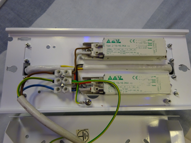 4X6w JSB ex emergency conversion, gear tray.
The gear for the bulkhead ended up being two Magnatek ballasts, a small blessing in disguise seeing as the factory pressed screw positions were the exact correct size to allow me to fit the ballasts without drilling additional holes. The only holes I've had to drill were for the lamp holder brackets and for the terminal block. Since all the starters are on the brackets, it makes this tray look empty, meaning the wiring job looks all the more tidier. Amazingly the ballasts don't actually get that warm, so at least the paint won't end up bubbling up and getting ruined by heat as it has in some of my other conversions sadly.
