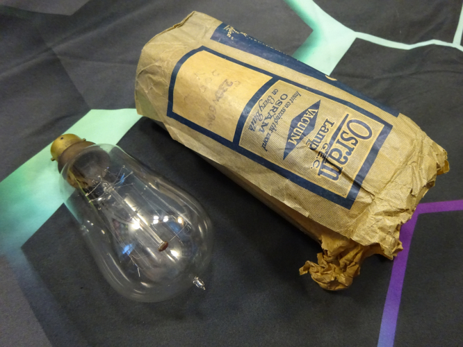 Osram vacuum squirrel cage lamp, with sleeve.
I picked this up today from an antique fair of all places. It was on a table full of other bits and pieces, in a old but very good condition sleeve. I looked into it to see this pip, and immediately knew it was something I needed to get. 

Getting back home, I was able to inspect it closer, and holy hell is this lamp beautiful. The etch is massive, it was also very faint so I filed down and rubbed some pencil lead into it which brought out its detail very well.

I've held it up to my screen to further show the detail. Its believed to date to between 1911 and 1913, meaning this will be my oldest working lamp, indeed the oldest item I have in the collection! Since its 220v though, it will not be lit without being on a variac, something this old needs to be brought up to light slowly rather than quickly, the shock of having power would literally kill it.
