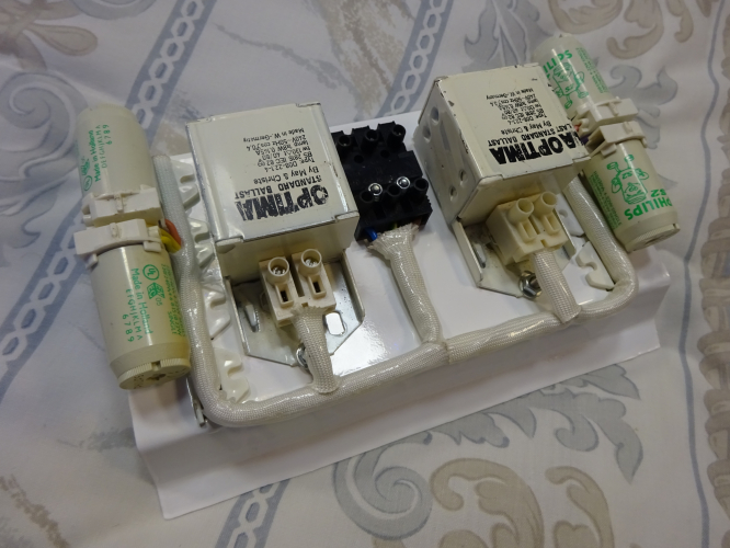 Quad 4w bulkhead build - Control gear layout.
Last month, a collector gave me a 6' fluorescent shop sign light, my intentions is to use that as a light for down the side of my lanterns shed. However one thing did put me off it, the fact it was about 19cm too long. I decided to cut it off, really tidying the fitting up, but then looking at the offcut, I wondered if I could make a second light from that.

After 3 weeks, this is the result, a quad 4w fitting. I had initially debated twin 9w PL, and even 10w 2D, but the latter is too rare now, and there's plenty of 9w PL fittings around. I have quad 8w bulkheads and have built a quad 6w fitting too, but a quad 4w isn't something I had yet made, hence my decision.

To build this, I had to cut two new end pieces to fit, and also design, cut and bend a piece of metal to form a gear tray with which the four tubes will be moved away from the diffuser, whilst also giving enough room for the gear to also fit comfortably too. It's definitely one of my most tightest and compact light builds to date, but its output is really evenly spread and controlled, even going as far as making the 4 tubes look like one even area of light.

Removing the tray from the light, one can inspect and maintain the gear very easily. In the end the wiring took me about an hour and a half, but it once again speaks for itself, as its another really good neat and tidy job. I've used heat sleeving because I thought it would get really hot in this fitting, but having it lit for a good few hours at a time, the light remains really quite cool to touch.

This has to be one of my most favourite creations yet, and hopefully very soon when we find the right one, its to be installed on the front of our house illuminating the number of our house, so will see plenty of good service!
