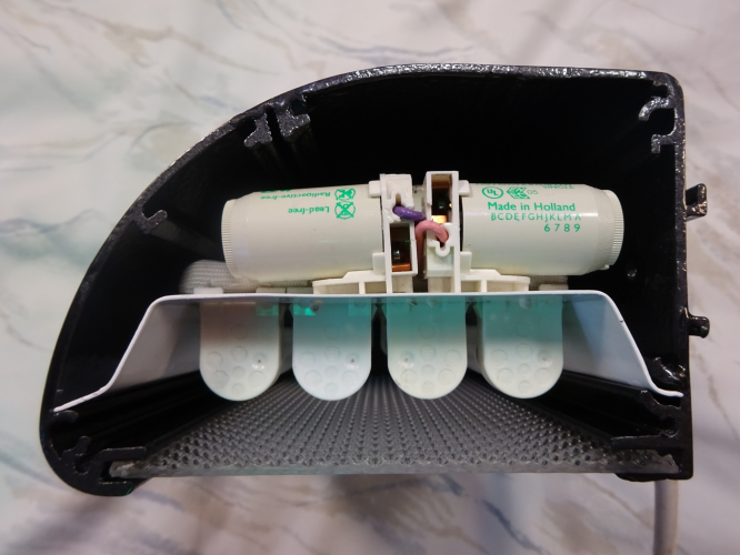 Quad 4w bulkhead light build - End cap removed.
Last month, a collector gave me a 6' fluorescent shop sign light, my intentions is to use that as a light for down the side of my lanterns shed. However one thing did put me off it, the fact it was about 19cm too long. I decided to cut it off, really tidying the fitting up, but then looking at the offcut, I wondered if I could make a second light from that.
 
After 3 weeks, this is the result, a quad 4w fitting. I had initially debated twin 9w PL, and even 10w 2D, but the latter is too rare now, and there's plenty of 9w PL fittings around. I have quad 8w bulkheads and have built a quad 6w fitting too, but a quad 4w isn't something I had yet made, hence my decision. 

To build this, I had to cut two new end pieces to fit, and also design, cut and bend a piece of metal to form a gear tray with which the four tubes will be moved away from the diffuser, whilst also giving enough room for the gear to also fit comfortably too. It's definitely one of my most tightest and compact light builds to date, but its output is really evenly spread and controlled, even going as far as making the 4 tubes look like one even area of light. 

With an end cap off, you can see just how tightly packed the gear is within the light. The whole tray simply slides out, hence my decision to fit a snap fit plug for the cable, as any major gear failure means the whole tray can be removed without disconnecting the electrics.

This has to be one of my most favourite creations yet, and hopefully very soon when we find the right one, its to be installed on the front of our house illuminating the number of our house, so will see plenty of good service!
