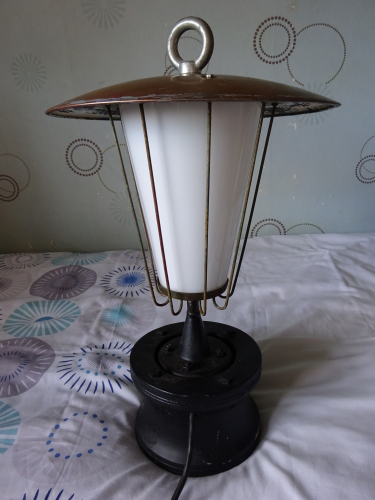 Falks GLS Pedestal lantern, before restoration.
I bought this beautiful Falks Pedestal light from an antiques flea fair I frequently visit in May, mounted on a very oversized and blocky wooden base that really doesn't match with the light well. The finials been replaced with an absolutely hideous lifting eye, and the three ball nuts on the canopy have also been replaced with normal hex nuts too, meaning its a nuisance to get into. Speaking with the seller, he wanted to bring its 'industrial' looks out, which imo is the wrong way to go about this, its more of a decorative functional light to my eyes.

Seeing past that, I knew the construction of the light is pretty much nothing but brass, and the cone surprisingly is glass. Knowing how well these clean up, I took a punt and bought it despite the nightmare I knew I'll have finding a replacement finial, especially since I don't even know what it looks like or even its dimensions. I gave it a quick power up not long after I got it home, and it really is a stunning looking light when lit.

After that, I immediately removed it from the wooden base, got that horrific lifting hook off and binned it, and then replaced the hex nuts back to the correct ball nuts. I could only get them in M4 thread, and since the originals are 4BA, that meant I had to drill upwards to 3/16 BSW, thread lock them in, cut them flush and drill and tap to the correct thread. 

Admittedly I'm a bit stuck regarding a new finial, ideally I need to find someone who has an example of these. The restoration will involve stripping all the paint off, before painting the underside of the canopy white, and then I'll simply polish and lacquer everything else to bring out the natural beauty of the brass. The base will be retained, but will be given to someone to turn the wood to a more appropriate shape, before staining it with a light coloured wax to compliment the brass. Whether I end up installing it outdoors though is another thing, it really is too nice to put outdoors again imo.
