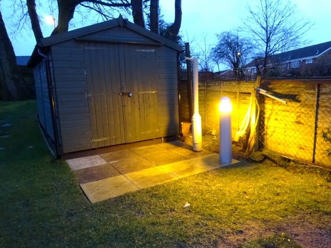 Ansell bollard restored, installed and lit.
The recently restored Ansell bollard has now been installed. For ages I've needed a light in front of the shed, especially in these dark winter nights, however I needed to make sure the light was kept at a low level, hence my reasoning for restoring this. The decision to add another row of slabs in front of the shed proved ideal for me to finally get it installed and out the way.

Prior to even finishing the restoration, I had installed all the wiring and switch gear comprising of a photocell, fused spur and light switch. The fused spur serves two purposes, it allows me to isolate both live and neutral, and allows me to turn it all off when the summer months are here. The light switch has been wired in to allow me to over ride the photocell without having to mess with the cell at all, a very handy feature.

To install it, I had to drill and tap a hole in the right angled brackets I got, and then drill the slab to allow me to screw those brackets down. A hole in the middle allows me to pass a piece of hosepipe through, which also doubles up as a protective means for the cable that is inside. I made sure to seal around the pipe to prevent ants from building their nests inside, and once the post was screwed down, a bead of clear silicone has been run round the bottom to prevent the ingress of water from below.

Light output is more impressive than i thought it would be, no doubt correct lamp positioning and the white internals help a huge deal, as it lights the slabbed area brilliantly, whilst allowing light a bit further beyond, creating a very soft, even spread of light. Overall, very very pleased with the outcome.
