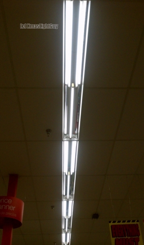 K-Mart Store Lighting
Lights at a K-Mart store. 

These would have at one point been 2-lamp 8-foot fittings, but as you can see, at some point got a crap retrofit job of alternating 1 / 2 lamp 4-foot.

(...well actually former K-Mart since its closed now...and to be former 'store' since they plan to demo the building too now. (to be replaced with apartments))

