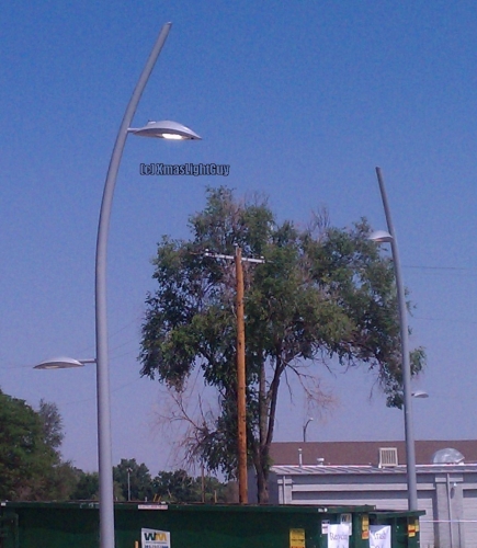 StreetLight #242
Here's some odd ones I saw back in 2016..no they didn't get caught in a tornado, the poles are purposely made all crooked/bent like that.

With the poles and the shape of the lights themselves (leaf-ish shaped) makes the whole thing look like some sorta strange plant. LOL (which is I'm assuming the effect they were going for)

According to one of the guys on GOL, lanterns are Philips Lumec CPLM (top) / CPLS (bottom). 

Location:
RTD Commuter Rail 'B' Line, Westminster CO Station. 
