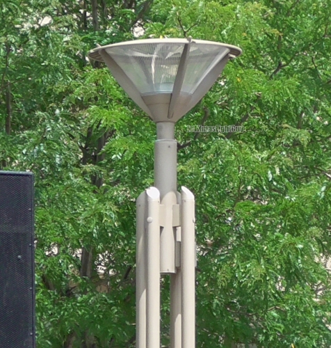 StreetLight #338 - Schreder Alura
 Fairly cool looking light to me (I also like the pole). Different versions of these exist, but HPS/SON were common, so these might be that.



Location:
Aurora Municipal Center/Aurora Public Library, Aurora, CO
