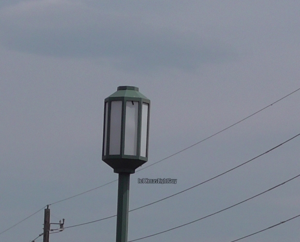  StreetLight #347 - Octagon Post-Top
 Neat looking old post-top fixture in a small shopping center's parking-lot.
They have some of these (which are probably more decorative than anything - and they're not in very good condition anymore - having holes in the white plastic side panels).
They also have some shoeboxes for more general lighting

This is probably early 1980's
Location:
Ken Caryl & Pierce, Jefferson County, CO
