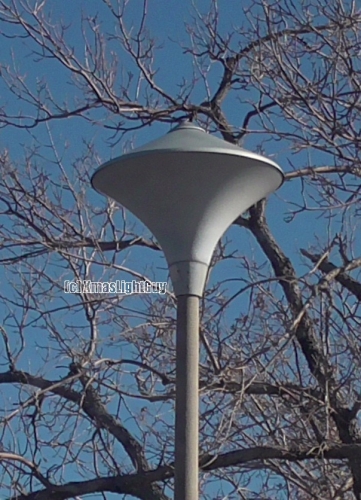 StreetLight #359 - UFO'ish Post Top
An old post-top, one that looks kinda like an UFO in shape .lol. 

There's a parking-lot that has 3 different type of cool old post-tops in it (this being one of them). I had been meaning to get a pic of these for some time, but its always busy there (and a place I don't go by all that often), so I never bothered until late last year.

Considering the way LEDs are quickly taking over everything, I figured better snap a pic while I have the chance...before these disappear.

I wouldn't be surprised if these were originally MV (they're SON now). They could be as old as 1969 - when the building was done.

Location:
3333 S Bannock St, Englewood, CO
