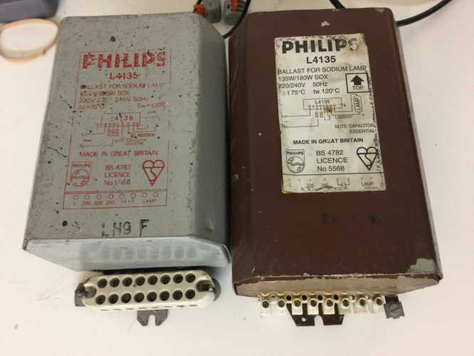 Philips L4135 Leak transformer 135W/180W SOX ballast comparison
here is what I think is an interesting comparison of 2 ballasts of the same model destination but separated by probably 30 years!

I always thought the more modern brown L4135's where identical to their older grey counter parts, apart from the colour/label scheme and terminal block style, but it turns out the more modern one is a little bit longer! (if anything id expect the older one to be longer!)

its also worth noting that the older ballast has a 200V tap and while that terminal is physically present on the newer ballast, its unmarked and indeed unconnected (which is something I had wondered about for a while), I wonder when the 200V tapping was dropped exactly

it is interesting to note how other than the above, the wording (and layout to a good degree) of the ballast etch/label is almost identical between them still despite the different styles and age difference

sadly the older grey ballast on the left has failed with internally shorted windings hence why I have the recently acquired brown ballast which was kindly supplied to me by Andy, and something im quite pleased to have, as the grey ballast died many years ago and since then I had been without a proper 180W SOX ballast until now
