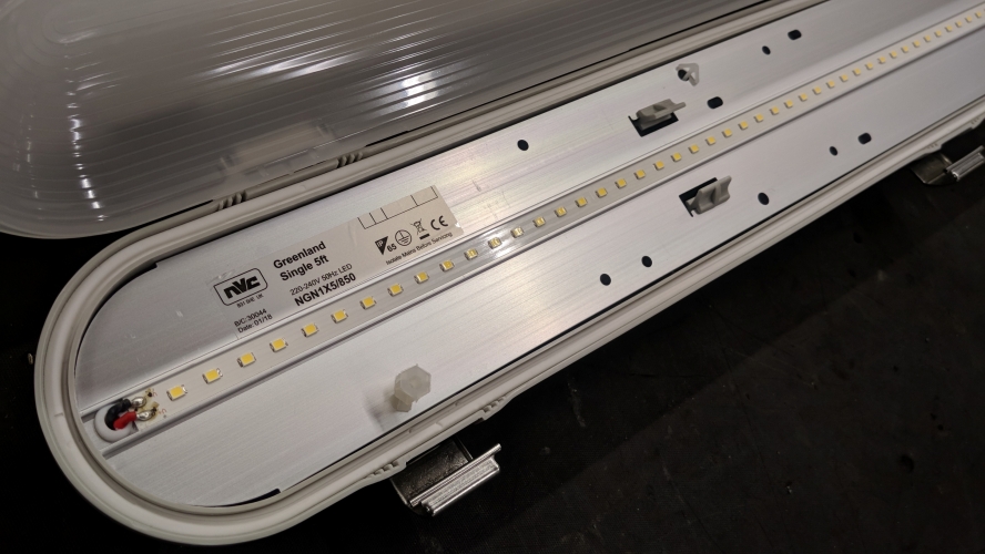 NVC Greenland LED fitting - Opened up

A look inside an NVC Greenland 5ft 36w LED weatherpack.

I noticed these fittings in the workshop at work so thought I'd take a closer look at them before they get installed to see what makes them tick.

First impressions are not great, the casing is made from thin plastic with no glass fibre reinforcement however there is a bit of extra moulding to add strength and they are also very light weight. The metal clips seem quite sturdy and maybe a bit pointless, seeing as they're only likely to get opened & closed a couple of times throughout the fittings life! The Aluminium gear tray is a welcome addition and should help sink heat away much better than painted steel would.

A quick look on the NVC website confirms these are rated to last 50,000 hours in an ambient temperature of 25 degrees C. I know where these are going and the ambient temperature is probably somewhere around there in winter, much higher in the summer so it'll be interesting to see how long they last.
