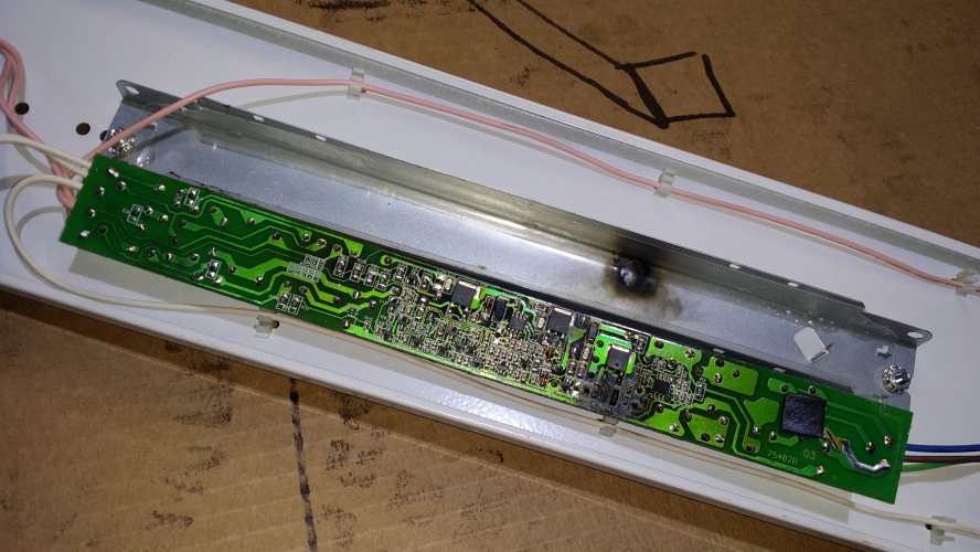 Toasted 18 Month Old Helvar T5 HF Ballast

The other side of the PCB from the Helvar ballast uploaded yesterday. Big sooty skid mark & looks like the transistors have been running incredibly hot!

I fitted it only about 18 months ago, it's been on 24/7 but that's still a very poor life at about 13,000 hours. The GE Starcoat tubes fitted were still fine.

It's been a pain since day one, it started life with (new) OSRAM tubes that it refused to drive properly, it kept shutting them down for no reason, and then it was allowing the tubes to rectify/light half wave & didn't shut them down! The Osrams were swapped for the GE Starcoat's that it still shut down a few times when they were new for no reason at all.

Another one of these ballasts was replaced last week by someone else, that one had the same black marks and a similarity crap lifespan (about 2 years).

Note: Used with 5ft HE 35w tubes in a cheepo Newlec fitting.

