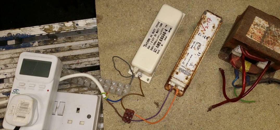 Fixed it! ...sort of
Got bored today so decided to have a look at this Thorn ballast that developed an earth fault not long after repainting it...

I rigged up my modified microwave oven transformer to output power between the coil of the ballast and the casing, but the voltage wasn't high enough to 'bridge' the fault. Fail.

Next, full 240v, through a 5' ballast to limit current. This worked a treat! About 50 watts was drawn for about 15 seconds before dropping to zero. Checked the ballast and it had got quite hot in a specific spot on the side, so much so it'd bubbled up the paint!

Tested the ballast and now it was about 50Mohm to earth at 500vdc. Interestingly after bashing the ballast about a bit, I managed to get it hard down to earth again, hmm...

After running the 240v from coil to casing method again, this time only required for about 2 seconds, it was now about 100Mohm clear of earth at 500vdc.

I'm pretty sure I now know what's going on here, corrosion inside the ballast that's bridging the coil to earth.

I've put the ballast on long-term test now, working fine again so far...
