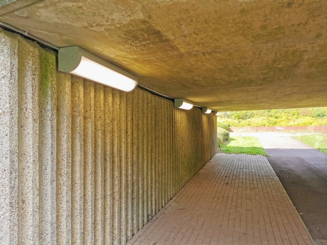 Milton Keynes Underpass Lighting Upgrades - Aug 2020 
This looks to be the latest type of LED strip lighting going into our underpasses.  This replaces what I believe are the original fluorescent bulkheads which used to be on the opposite side of this underpass (no idea why they moved to this side rather than just replacing the originals in situ, which were still working...so not a cable issue!).  The originals had their tubes replaced with LED ones a few years ago and really didn't produce much useful light after that "upgrade" so this is definitely providing better light.  

They don't appear from a passing look and a poke at the diffuser to be massively robust, but we'll see how they do as time passes.
Keywords: streetlighting;underpass;led;bulkhead