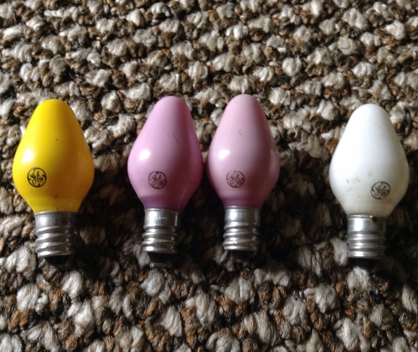 GE C7 Ceramic Coated C7 Christmas Bulbs In More Rarer Colors 
Garage sale find in older 7 socket twisted wire strings. The most rarest being the canary yellow ( much like a bug lite yellow instead of the more common orange) 2 pinks and an white which are more harder to find.
