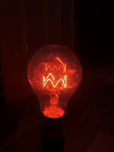 BHS Fireglow GLS incandescent bulb lit up 
This 60W incandescent bulb that's Fireglow red made for BHS lit up

I love the zig zag filament 
