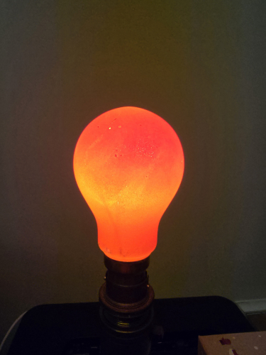 Atlas orange coloured 25W GLS bulb lit up 
This one is unique with the pattern/gradient effects thanks to the external coating method 
