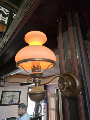 Wall light with candle flame LED bulb 
At the saloon bar of Sioux City theme park 

Has a nice orange colour to it and very much reminds me of the LED battery powered candles you can get 
