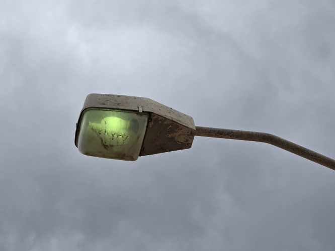 Wall mounted streetlight at Playa del Ingles beach, Maspalomas, Gran Canaria 
Has a dim glowing MV bulb 
