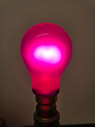 Crompton 40W Ruby Red "property of HM Government" bulb lit up
The deepest, gentlest and vibrant red coloured GLS incandescent bulb I've ever seen, thanks to the top tier method of using actual Ruby Red coloured glass and not some ceramic or external spray paint job
