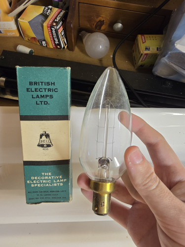 BELL clear 60W candle bulb with long U shaped filament 
A nice large sized pointy designed candle bulb by BELL Wimbledon 

60W and has a U shaped filament- actually please to have it in clear as the Philips twisted bulb I've got from the car boot sale had the same filament shape but the bulb finish is frosted 
