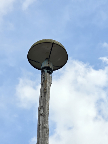 Helmet shaped railway track posttop floodlight 
These can be seen on some parts of the railway in Germany 

These defo use MV bulbs
