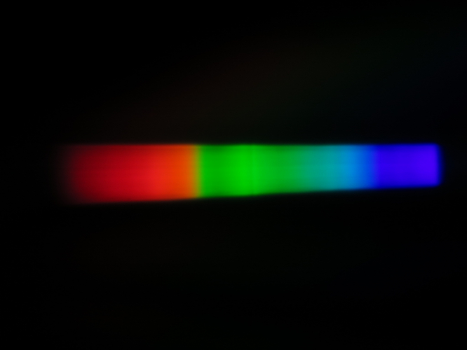 Spectrum of a UHP lamp of a media projector
[img]https://i.postimg.cc/bwV7ht34/IMG-1087.jpg[/img]
I captured this spectrum from an Epson media projector, when I was at a 3D printing class for people with disabilities like intellectual disability. This was a year before the COVID-19.
The mercury pressure here is 200bar, and the mercury lines are very wide and almost merging with the strong continuous molecular spectrum.
There is a strange dark line at the mercury green band which I don't know what it is, since the optical mercury lines aren't resonance lines.
A higher resolution spectrum:
[url=https://postimg.cc/gx940mwL][img]https://i.postimg.cc/gx940mwL/IMG-1239.jpg[/img][/url]
Unfortunately, even in media projectors, HID loses to LED, as it is much cooler and smaller, so the media projector can be very small, but LED don't have so interesting spectrum like UHP.
