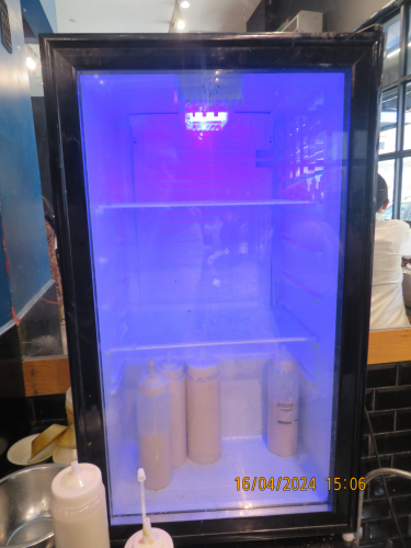 Refrigerator with a blue LED lamp inside in a swarma restaurant
[img]https://i.postimg.cc/bwYsC4wn/IMG-8069.jpg[/img]
The blue light is so deep and narrow band, that the camera seeing it as a purplish colour.
